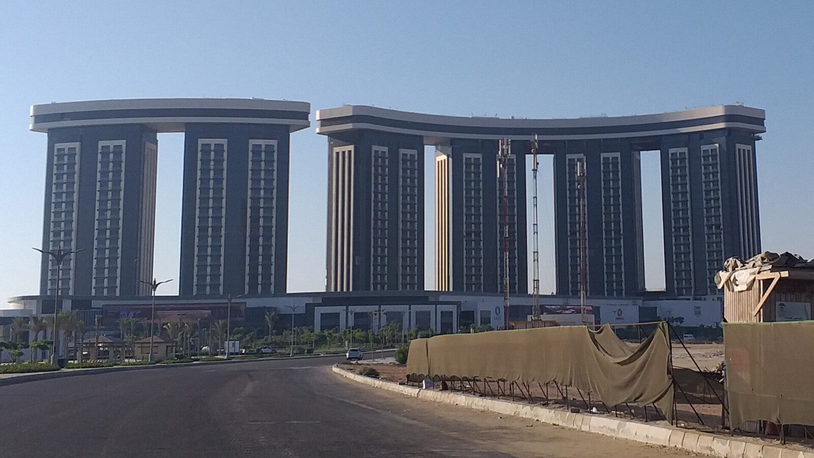 The Gate towers of New Alamein under a blue sky