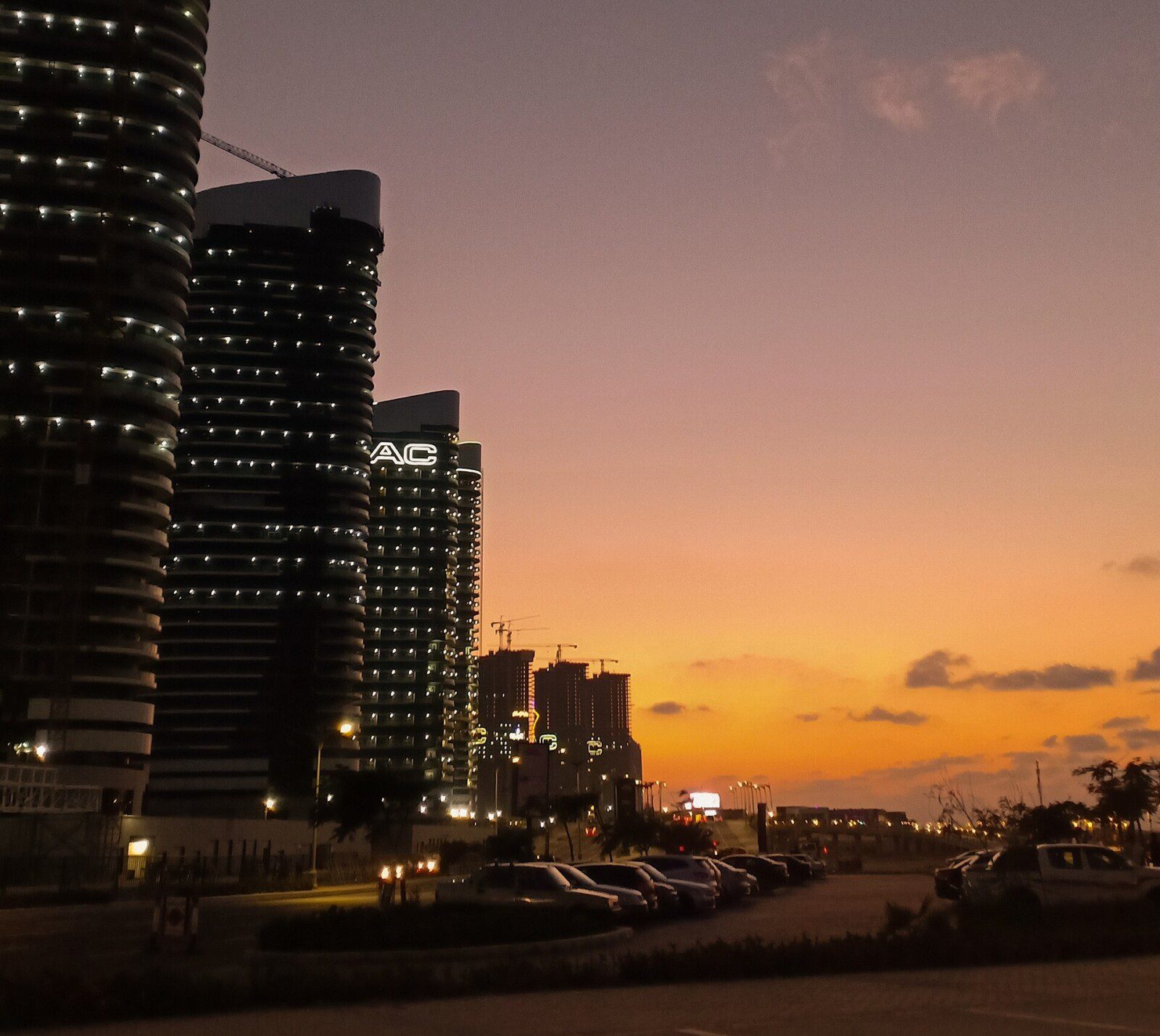New Alamein towers lit at night with a sunset sky